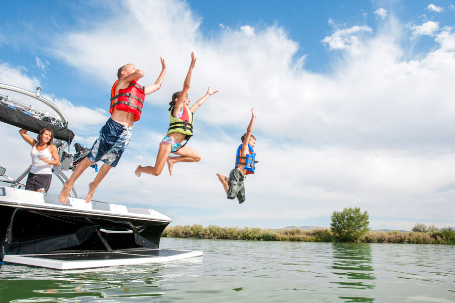 children-jumping-off-boat-into-water-boat-insurance-the-insurance-outlet