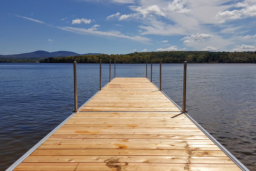 Laconia, NH - View of Dock at a Lake in Laconia, New Hampshire on a Sunny Day